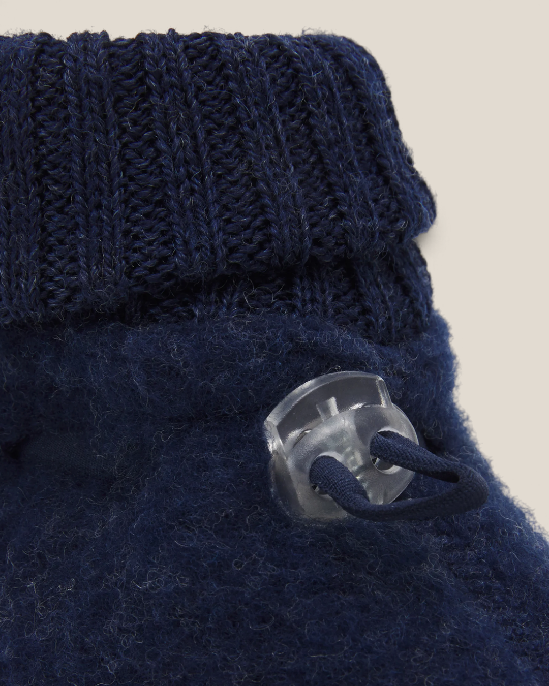Sprall mörkblå ulltossor i mjuk merinoull med ribbad mudd och praktiskt snörlås för en bekväm passform.